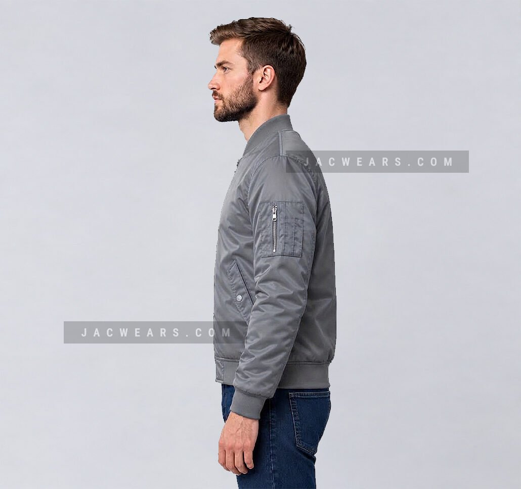 Custom grey nylon bomber jacket with utility sleeve pocket, angled view