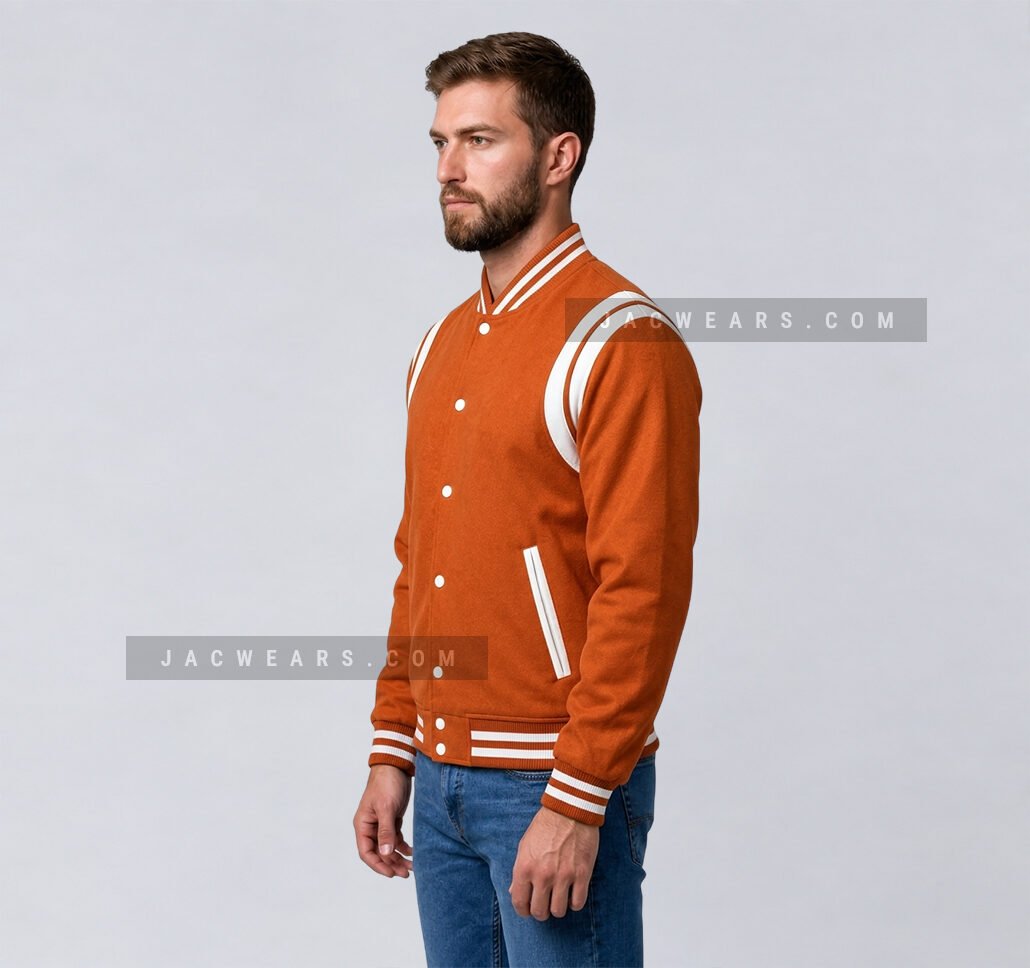 Custom orange wool letterman jacket with white shoulder inserts, angled view
