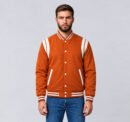 Custom orange wool letterman jacket with white shoulder inserts, front view